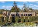 An impressive brick entrance sign reads 'Belle Harbor', surrounded by manicured landscaping and colorful flowerbeds at 865 Summer Starling Pl., Myrtle Beach, SC 29577