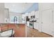 Modern kitchen with stainless steel appliances, white cabinets, and a breakfast bar overlooking the living area at 865 Summer Starling Pl., Myrtle Beach, SC 29577
