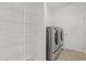 Efficient laundry room with shelving and modern washer and dryer units at 865 Summer Starling Pl., Myrtle Beach, SC 29577