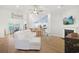 Bright, open-concept living room with vaulted ceilings, fireplace, modern furniture, and breakfast bar at 865 Summer Starling Pl., Myrtle Beach, SC 29577