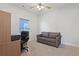 Carpeted home office featuring a comfortable sofa, work desk, and natural light at 865 Summer Starling Pl., Myrtle Beach, SC 29577