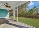 Inviting screened porch with fan, accessible door, and a view of the expansive backyard at 865 Summer Starling Pl., Myrtle Beach, SC 29577