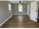 Bedroom includes a ceiling fan, windows, wood-look flooring, and closet at 876 S Clay Field Rd, Johnsonville, SC 29555