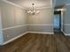 Elegant dining room with modern chandelier, light-colored walls, hardwood floors, and white trim at 876 S Clay Field Rd, Johnsonville, SC 29555