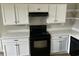 Kitchen showcasing white cabinets, black appliances, and sleek countertops at 876 S Clay Field Rd, Johnsonville, SC 29555