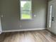Inviting living room featuring hardwood floors, neutral walls, and a bright window view at 876 S Clay Field Rd, Johnsonville, SC 29555
