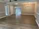 Spacious living room with light-colored walls, white trim, hardwood floors, and ample natural light at 876 S Clay Field Rd, Johnsonville, SC 29555