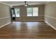 Inviting living room featuring hardwood floors, neutral walls, a fan, and a bright window view at 876 S Clay Field Rd, Johnsonville, SC 29555