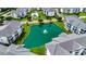 Aerial view showcasing a pond, pool, and the layout of the community at Carolina Keyes at 901 West Port Dr. # 712, North Myrtle Beach, SC 29582
