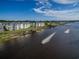 Stunning aerial view of waterway with condos and a jet ski, showcasing the property's beautiful waterfront location at 901 West Port Dr. # 712, North Myrtle Beach, SC 29582