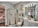 Bright bathroom with a shower, vanity with a sink, stacked towels, and beach themed wall decor at 901 West Port Dr. # 712, North Myrtle Beach, SC 29582