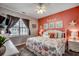 Cheerful bedroom with coral accent wall and coastal decor, featuring a plush bed and ample natural light at 901 West Port Dr. # 712, North Myrtle Beach, SC 29582