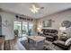 Inviting living room featuring a coastal theme, modern fan, and sliding glass doors to the porch at 901 West Port Dr. # 712, North Myrtle Beach, SC 29582