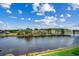 Breathtaking water view from a sunroom window showcasing waterfront homes and lush foliage at 901 West Port Dr. # 712, North Myrtle Beach, SC 29582