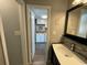 View into the kitchen from the bathroom, featuring a single sink and tiled backsplash at 920 N Waccamaw Dr. # 2206, Garden City Beach, SC 29576