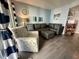 Inviting living room boasts a comfortable sectional, patterned accent chair, and sliding door for natural light at 920 N Waccamaw Dr. # 2206, Garden City Beach, SC 29576