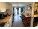 Cozy kitchen overlooks the living room, with dining area and access to a balcony with natural light at 920 N Waccamaw Dr. # 2206, Garden City Beach, SC 29576
