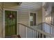 Inviting entryway with a charming green door adorned with a wreath, complemented by a patterned welcome mat at 9400 Shore Dr. # 411, Myrtle Beach, SC 29572