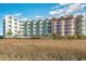 Coastal property offering relaxing grassy beachfront, charming architecture, and breathtaking views at 9400 Shore Dr. # 411, Myrtle Beach, SC 29572
