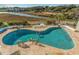 Inviting pool with brick surround and views of a waterway and surrounding lush vegetation at 9400 Shore Dr. # 411, Myrtle Beach, SC 29572