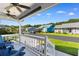Inviting covered porch with comfortable seating and a view of the quiet neighborhood street at 9466 Old Palmetto Dr., Murrells Inlet, SC 29576