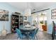 Charming dining area with a round glass table, wicker chairs, and a view of the sunroom at 9466 Old Palmetto Dr., Murrells Inlet, SC 29576