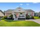 Charming single-story home with a covered porch, bright pink accents, and a well-manicured lawn at 9466 Old Palmetto Dr., Murrells Inlet, SC 29576