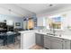 Bright and modern kitchen with white cabinets, stainless steel appliances, and an open layout to the dining area at 9466 Old Palmetto Dr., Murrells Inlet, SC 29576