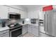 Bright kitchen with stainless steel appliances, light-colored cabinets, and a modern backsplash at 9466 Old Palmetto Dr., Murrells Inlet, SC 29576