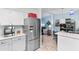 Open-concept kitchen featuring stainless steel refrigerator and seamless flow into the living room at 9466 Old Palmetto Dr., Murrells Inlet, SC 29576