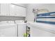 Bright laundry room with ample storage, modern washer, and dryer for convenient chores at 9466 Old Palmetto Dr., Murrells Inlet, SC 29576
