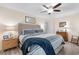 Inviting primary bedroom with wood-look floors, ceiling fan, and a comfortable king-sized bed at 9466 Old Palmetto Dr., Murrells Inlet, SC 29576