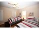 Bright bedroom features two beds, coastal decor, and a ceiling fan at 950 Tiffany Ln., North Myrtle Beach, SC 29582