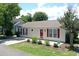 Charming home featuring a red door and shutters, complemented by a well-manicured front yard at 950 Tiffany Ln., North Myrtle Beach, SC 29582