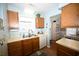 Modern kitchen with stainless steel sink, white appliances, and wood cabinets at 950 Tiffany Ln., North Myrtle Beach, SC 29582