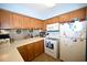 Kitchen with white appliances, solid surface countertops and wood cabinets at 950 Tiffany Ln., North Myrtle Beach, SC 29582