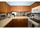 Kitchen with white appliances, solid surface countertops, and wood cabinets at 950 Tiffany Ln., North Myrtle Beach, SC 29582