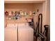 Laundry closet with stacked washer and dryer, shelving and cleaning supplies at 950 Tiffany Ln., North Myrtle Beach, SC 29582