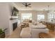 Cozy living room with a fireplace, neutral decor, and an adjacent open-concept dining area at Simpson Creek Dr., Loris, SC 29569