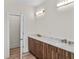 Bright bathroom featuring double vanity with marble countertop and modern fixtures at 1028 Colette Ct, Conway, SC 29526
