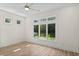 Bedroom with large windows overlooking lush backyard and pond at 1028 Colette Ct, Conway, SC 29526