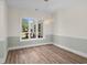 Dining room with modern chandelier and large window overlooking the yard at 1028 Colette Ct, Conway, SC 29526