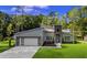 Beautiful home with a modern design, surrounded by lush greenery that enhances its natural beauty and curb appeal at 1028 Colette Ct, Conway, SC 29526