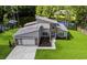 Stunning home with modern design, lush landscaping, and a serene pond view, enhancing its curb appeal at 1028 Colette Ct, Conway, SC 29526
