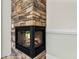 Corner fireplace with stone surround and glass door at 1028 Colette Ct, Conway, SC 29526