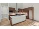 Modern kitchen featuring sleek cabinetry, stainless steel appliances, quartz countertops, and hardwood floors at 1028 Colette Ct, Conway, SC 29526