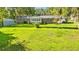 Back of home with a well-manicured lawn, storage shed, and covered parking at 1032 Chelsey Circle, Conway, SC 29526