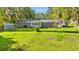 Back of home with a well-manicured lawn, storage shed, and covered parking at 1032 Chelsey Circle, Conway, SC 29526