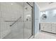 Accessible shower stall with bench, grab bar, and tile surround next to vanity at 1032 Chelsey Circle, Conway, SC 29526