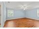 Bright bedroom features wood floors, a ceiling fan, neutral paint, and large windows at 1032 Chelsey Circle, Conway, SC 29526